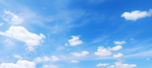 Wall Mural - Soft white clouds with a beautiful blue sky in the morning light. Soft white clouds float in the clear blue sky. Clear blue sky, bright spring, soft sky gradient.