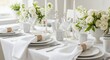 © Aka - Elegant White Wedding Table Setup with Roses and Glassware