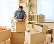 © Lumos sp - Portrait of a young man guy unpacking boxes after moving in and relocation in a new apartment, or packing to move out