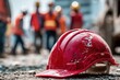 © Serhii - Close-Up of Red Hard Hat with Blurred Background of Injured Workers at Construction Site