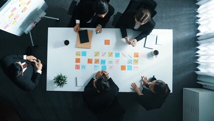 Wall Mural - top down aerial view of professional business people listening investor explain strategy at meeting 