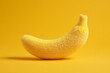 © Pacharee - Fuzzy banana with soft texture on yellow background. Creative and surreal fruit design.