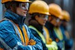 © MUHAMAD MUHSON - Teamwork and Safety: A Group of Focused Construction Workers