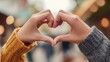 © Johannes - Closeup shot of young man and woman making heart shape with hand. Loving couple making heart shape with hands outdoor. Female and male hands making up heart shape., no logos, no brands