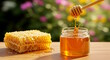© gv image - Honey dripping from wooden honey dipstick and falling in glass jar of natural organic honey with honeycomb, natural flower soft blur background