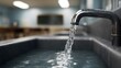 © Thares2020 - Water flowing from a faucet in a school bathroom