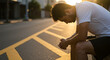 © Syartinolky | Pixels - Exhausted young athlete sits alone on curb after difficult workout