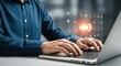 © Nimra - A man is typing on a laptop with security icons floating above, ensuring data protection