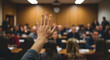 © Sulfabndi - A student raises their hand to ask a question during a lively and engaging classroom lecture.