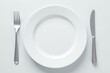 © Lawan - Elegant empty white plate with polished silver fork and knife , still life, utensils, background