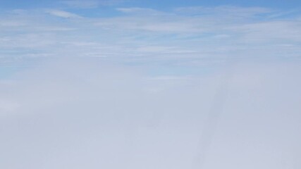 Wall Mural - Aerial view above the clouds and sky inspiration concept in cinematic breathtaking aerial flying over white fluffy cloudscape in high altitude sky with fresh clean air and blue skies on background.