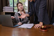 © SOMKID - Two Lawyer with Document Paper and Hammer on Wood table,  Judge's Gavel, Law, Justice Symbol, Agreement and Partnership Concept,