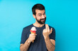 © luismolinero - Young man with a cornet ice cream over isolated blue background inviting to come with hand. Happy that you came