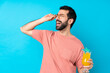 © luismolinero - Young man over holding a cocktail over isolated blue background with glasses and happy