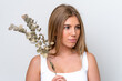 © luismolinero - Young caucasian woman isolated on white background holding a eucalyptus branch. Close up portrait