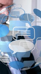 Wall Mural - animation of globe with speech bubble over caucasian businessman using laptop
