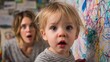 © Supachok - toddler holding crayon near freshly scribbled wall, mom reacting in surprise, colorful child art in background, everyday parenting chaos photography
