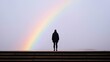 © KWANMANAT - Person Standing Under a Rainbow Symbolizing Hope and New Beginnings