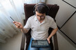 © ADDICTIVE STOCK - Man learning mandarin online from home