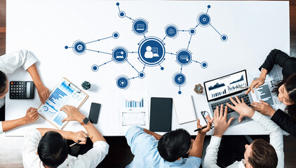 a diverse group collaborates in a modern office, utilizing technology and data analysis tools to dri