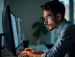 © MediaPro - Jeune développeur concentré sur son écran, codant intensément dans un bureau moderne de nuit