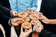 © InfiniteFlow - A dynamic business team collaborates, each person holding wooden gears that symbolize growth and innovation in a modern work environment, promoting teamwork and success. Amity
