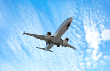 Wall Mural - airplane flying in beautiful blue sky with clouds