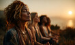 © john - diverse group of women meditating in nature at sunset, finding inner peace and harmony in a serene outdoor setting.
