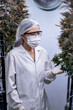 © ultramansk - A scientist inspects cannabis plants in a controlled indoor farm for quality assurance and research. Medical marijuana cultivation advances through innovation, biotechnology, and sustainability.