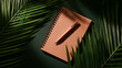 © Creative Studio  - Terracotta notebook with pen and palm leaves green