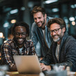 © john - Three diverse businessmen collaborate, analyze business plan on laptop in office. Smiling faces, teamwork, project management. Partnership, advisor discussion, business idea online, tech solutions