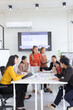 © SOMKID - Group of business people discussing work together and analysis data in a meeting room,
