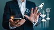 © Moma888 - Businessman using smartphone with ai and business growth icons representing innovation and success