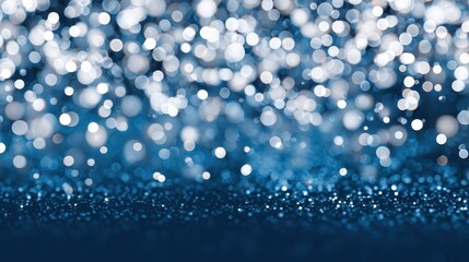 Festive blue and white bokeh background with glitter.
