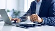 © Stock Contributor - Business person completing digital checklist with pen on tablet near laptop and phone