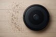 © Robbany Hossain - Black robotic vacuum cleaner cleaning dirt and debris from wooden floor