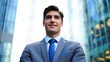 © Lens Vivid - Portrait of successful businessman in suit looking up at skyscrapers in city center