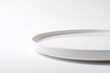 © Alexander - white round plate isolated on white background with soft lighting and minimal shadow
