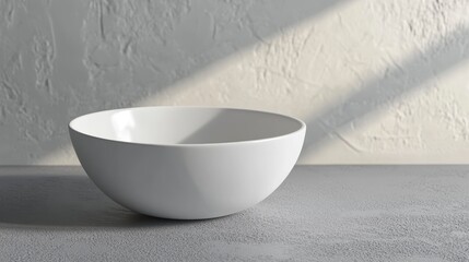 Wall Mural - empty white bowl on grey surface with sunlight.