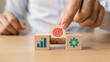 © MdMojibor - Strategic Business Blocks A Hand Stacking Wooden Cubes with Target, Growth, and Gear Icons for Planning and Achieving Success on a Wooden Tabletop