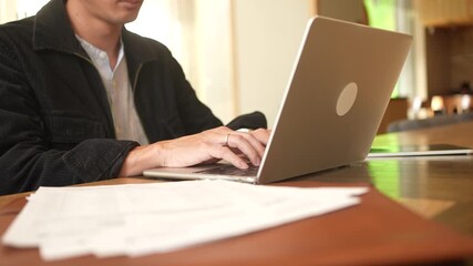 programmer man hand typing configuration on keyboard at laptop for input coding language to software