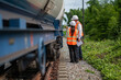 © APchanel - Engineer manager and a secretary working together railway track during inspection or routine maintenance gas or oil power industrial or transportation setting the rail train import export logistics