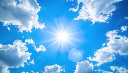 Wall Mural - Bright sun shining in a clear blue sky scattered with fluffy white clouds on a sunny day.