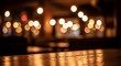 © SnapHive - Warm glowing bokeh lights illuminate a wooden bar top in a dimly lit restaurant or pub