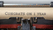 © KENZOGROW - Happy Work Anniversary and thank you. Vintage typewriter with the message 'Congrats on 1 year' displayed on its paper.