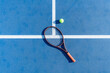 © frank schrader - High-angle view of tennis racket and ball on court surface