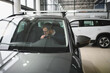 © Serhii - Man buying a car at a showroom