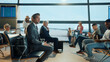 © Videophilia - Businessman waiting for flight in airport lounge with diverse passengers