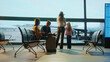 © Videophilia - Family waiting for boarding in airport lounge watching airplane