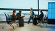 © Videophilia - Passengers waiting in airport lounge checking tickets and departures board